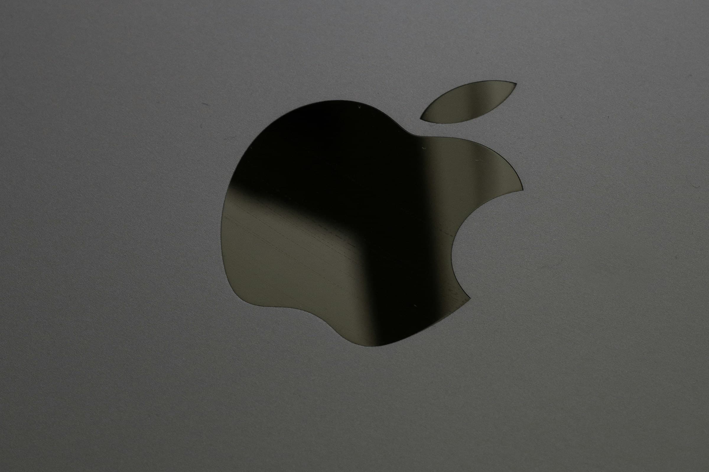 Close-up of the Apple logo on a MacBook lid